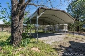 view of parking / parking lot featuring a carport