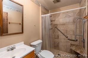 bathroom featuring a shower with curtain, vanity, and toilet