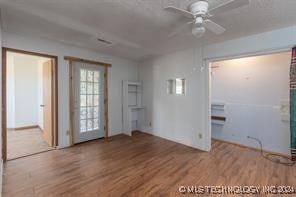 interior space with ceiling fan and wood-type flooring