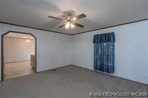 empty room with carpet flooring and ceiling fan