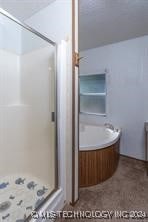 bathroom featuring shower with separate bathtub