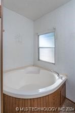 bathroom with a tub to relax in