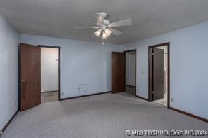 unfurnished bedroom featuring light carpet and ceiling fan