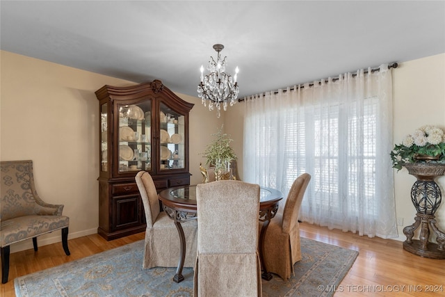 dining area featuring a notable chandelier and light hardwood / wood-style flooring