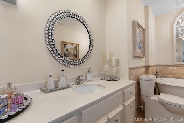 bathroom with toilet, a tub, and vanity