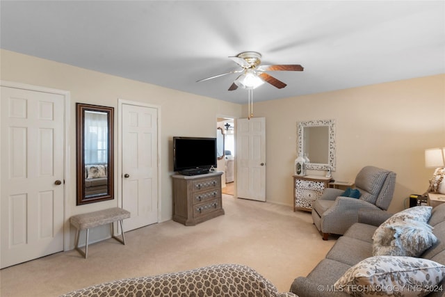 carpeted living room featuring ceiling fan