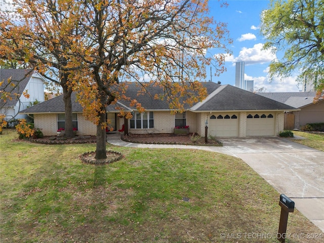 ranch-style house featuring a front lawn and a garage