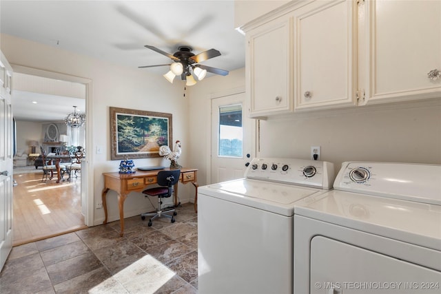 laundry room featuring ceiling fan with notable chandelier, cabinets, and separate washer and dryer