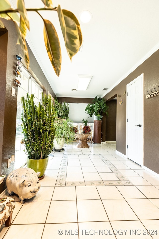 corridor featuring tile patterned floors and ornamental molding