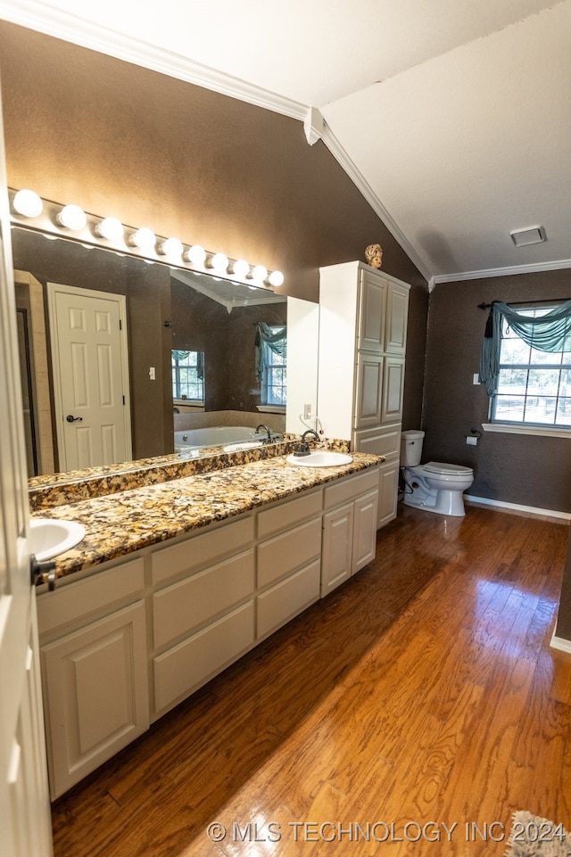 bathroom with vanity, crown molding, hardwood / wood-style floors, toilet, and lofted ceiling