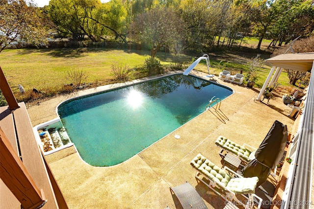 view of swimming pool featuring a patio area and a water slide