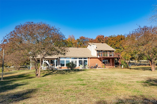 back of house with a yard and a deck