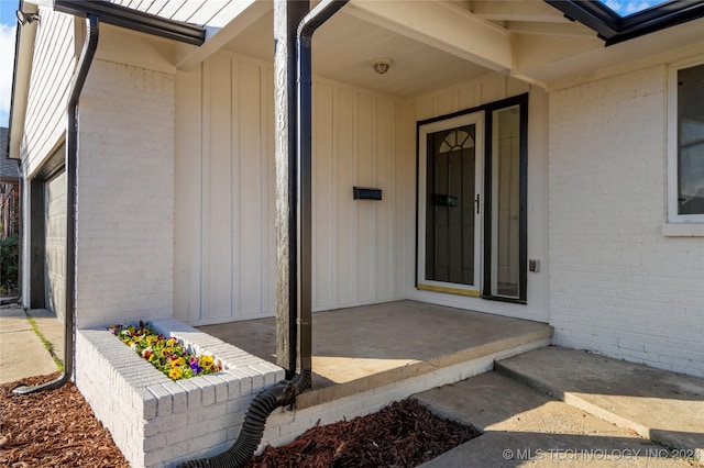 view of exterior entry with a garage