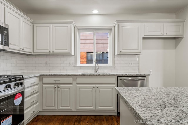 kitchen featuring white cabinetry, sink, stainless steel appliances, and light stone counters