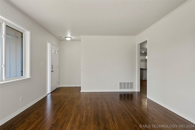 unfurnished room featuring dark hardwood / wood-style flooring and ornamental molding