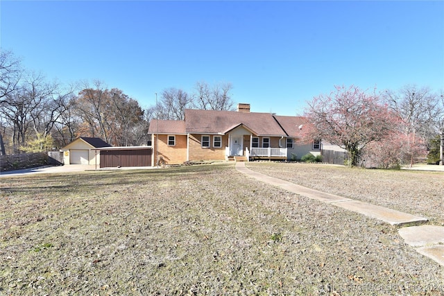 view of front of house featuring an outbuilding, a porch, and a garage