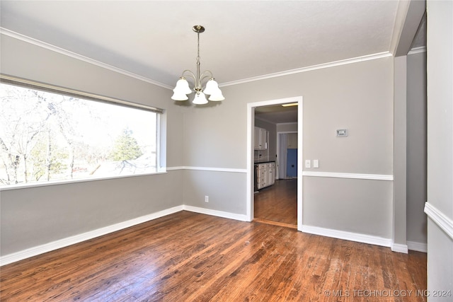 unfurnished room with a chandelier, dark hardwood / wood-style floors, and ornamental molding