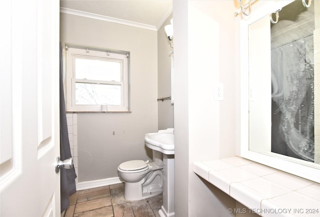 bathroom featuring toilet and crown molding