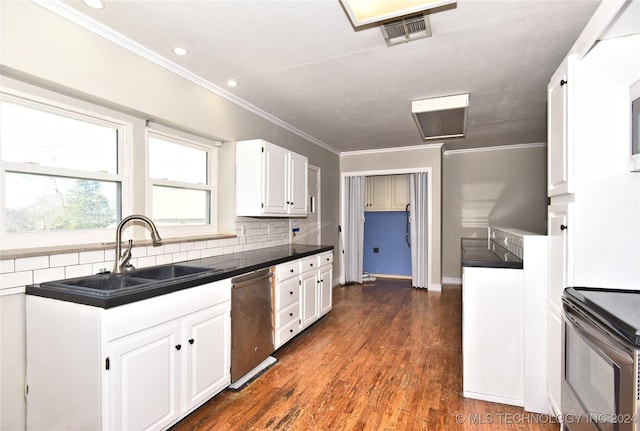 kitchen featuring appliances with stainless steel finishes, tasteful backsplash, sink, white cabinets, and dark hardwood / wood-style floors