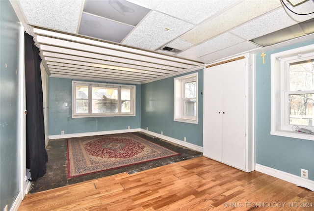 entryway with hardwood / wood-style floors and a paneled ceiling