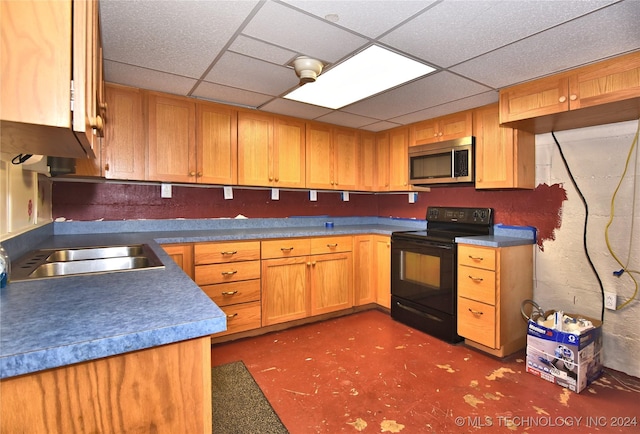 kitchen featuring a paneled ceiling, black electric range oven, and sink