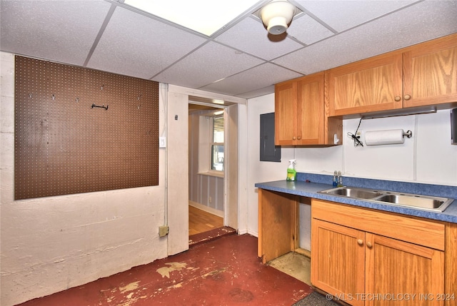 kitchen with electric panel and a drop ceiling