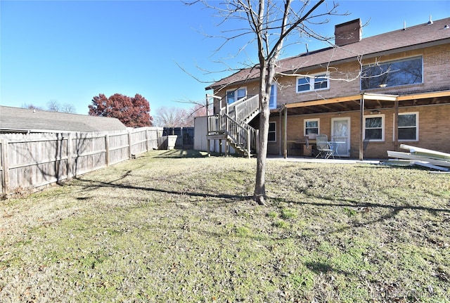 back of house featuring a yard