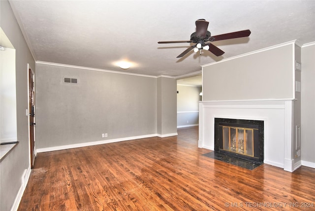 unfurnished living room with a textured ceiling, dark hardwood / wood-style floors, ceiling fan, and ornamental molding