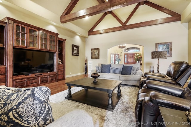 living room featuring beamed ceiling, wood-type flooring, an inviting chandelier, and high vaulted ceiling