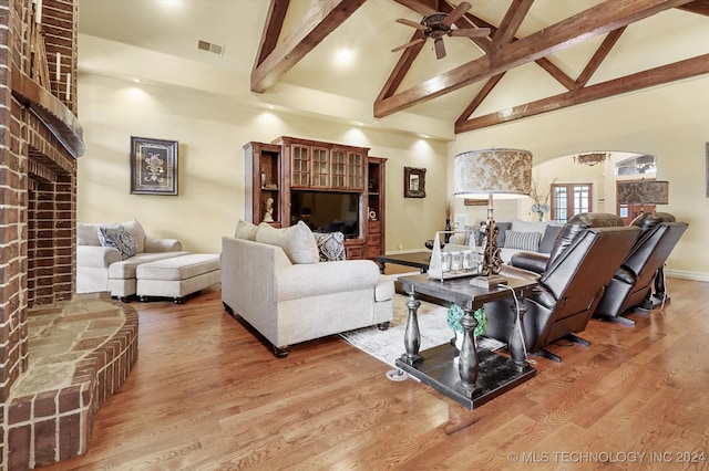 living room featuring hardwood / wood-style flooring, high vaulted ceiling, and ceiling fan