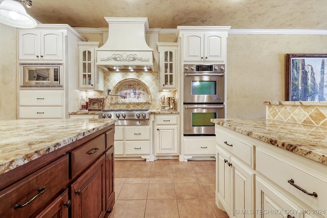 kitchen with crown molding, stainless steel appliances, and custom range hood