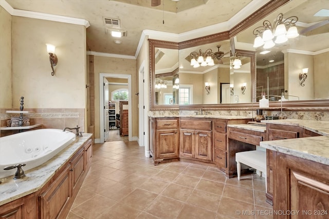 bathroom with tile patterned flooring, vanity, crown molding, and a tub