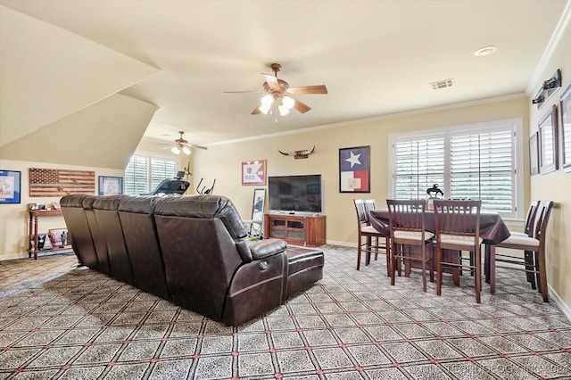 carpeted living room featuring a wealth of natural light, crown molding, and ceiling fan