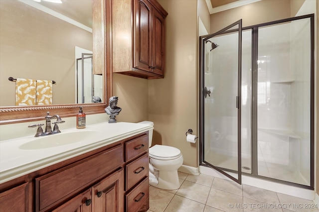 bathroom featuring tile patterned flooring, crown molding, an enclosed shower, toilet, and vanity