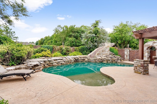 view of pool with a patio area and a water slide