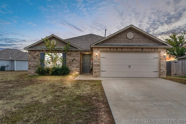 ranch-style house with a lawn and a garage