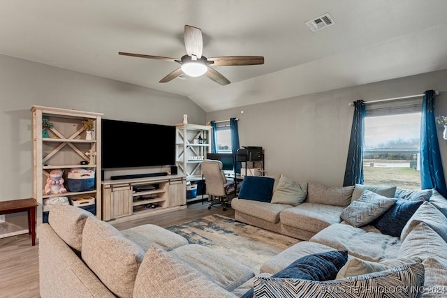 living room featuring ceiling fan, lofted ceiling, and light wood-type flooring