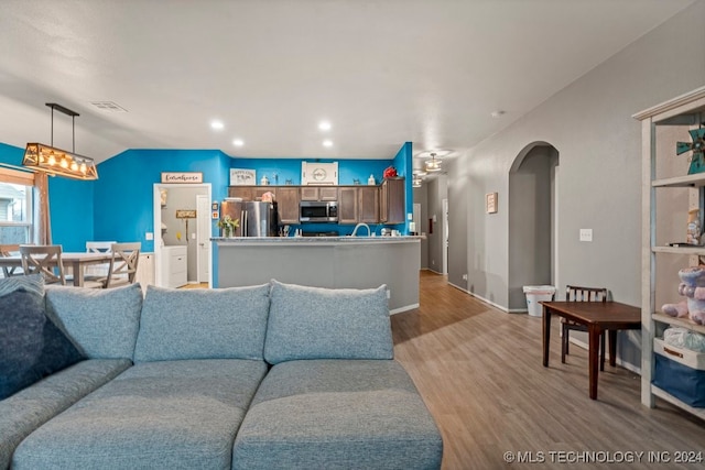 living room featuring light hardwood / wood-style flooring and lofted ceiling