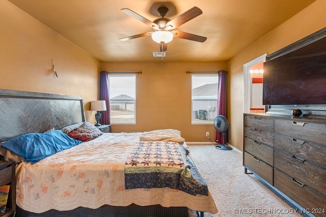 bedroom with light carpet and ceiling fan