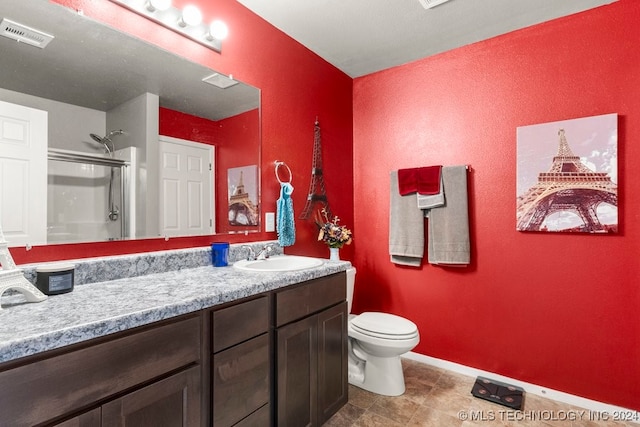 bathroom with vanity, toilet, and walk in shower