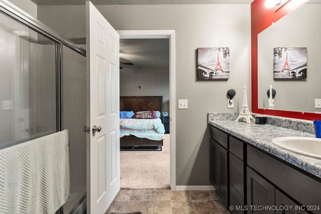 bathroom featuring a baseboard heating unit, vanity, and a shower with shower door