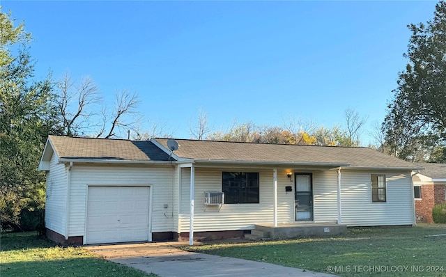 ranch-style house featuring a front yard, a wall mounted air conditioner, and a garage