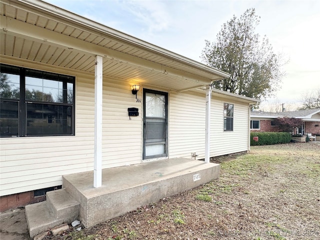 property entrance featuring covered porch