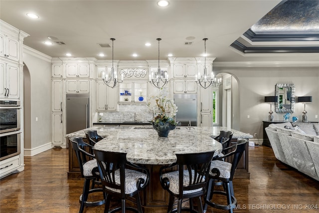 kitchen featuring pendant lighting, a spacious island, and stainless steel appliances