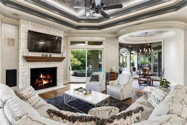 living room featuring hardwood / wood-style floors, plenty of natural light, crown molding, and a tray ceiling