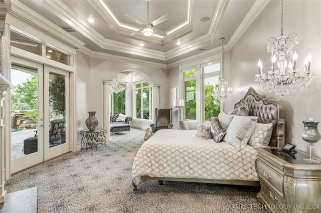 carpeted bedroom featuring multiple windows, french doors, and access to exterior