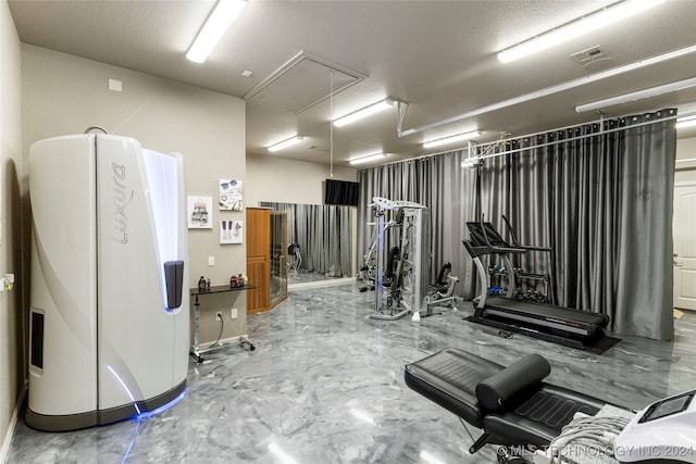 workout area featuring a textured ceiling