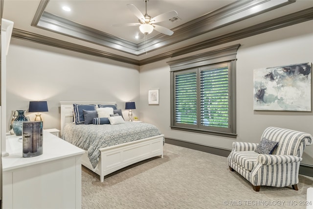 bedroom with a raised ceiling, ceiling fan, and ornamental molding