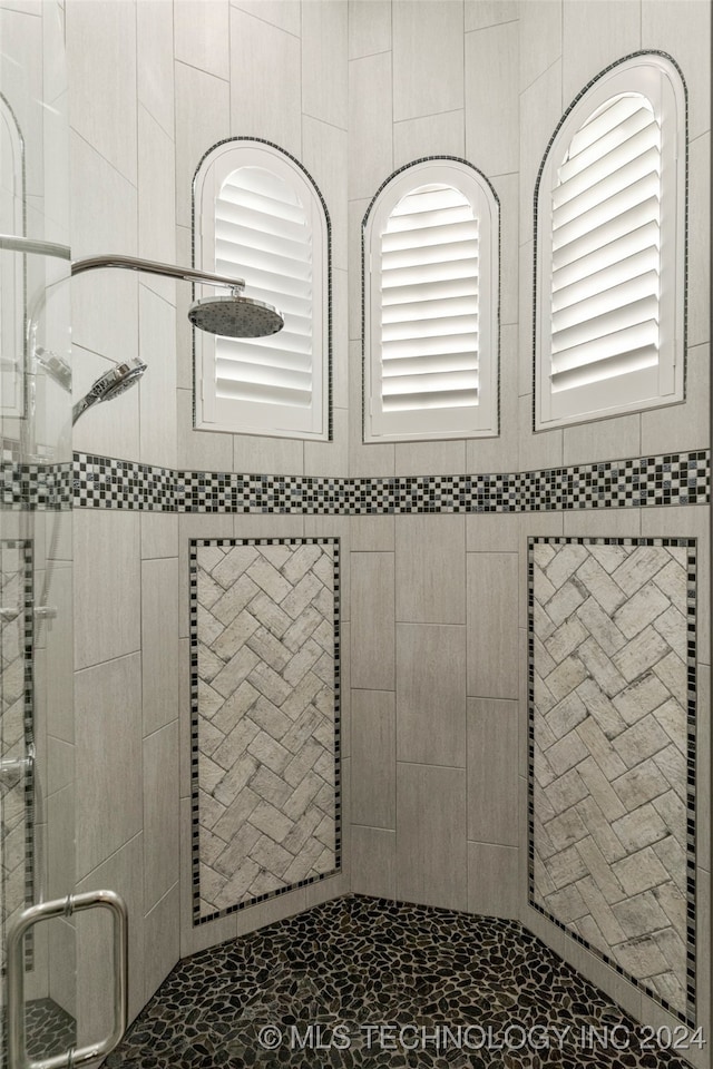 interior details featuring a tile shower