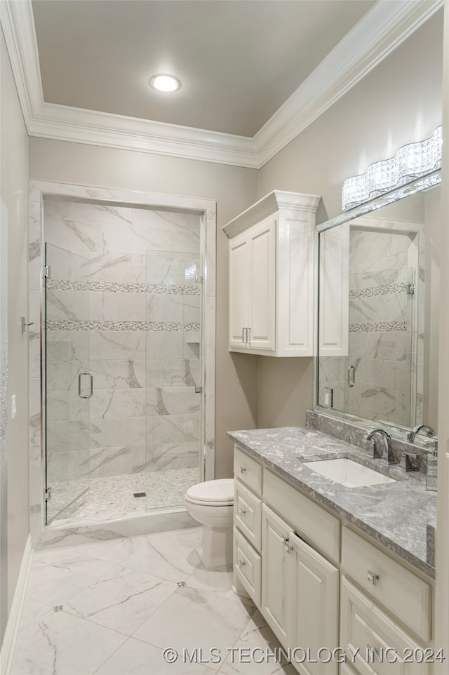 bathroom featuring vanity, toilet, a shower with door, and crown molding